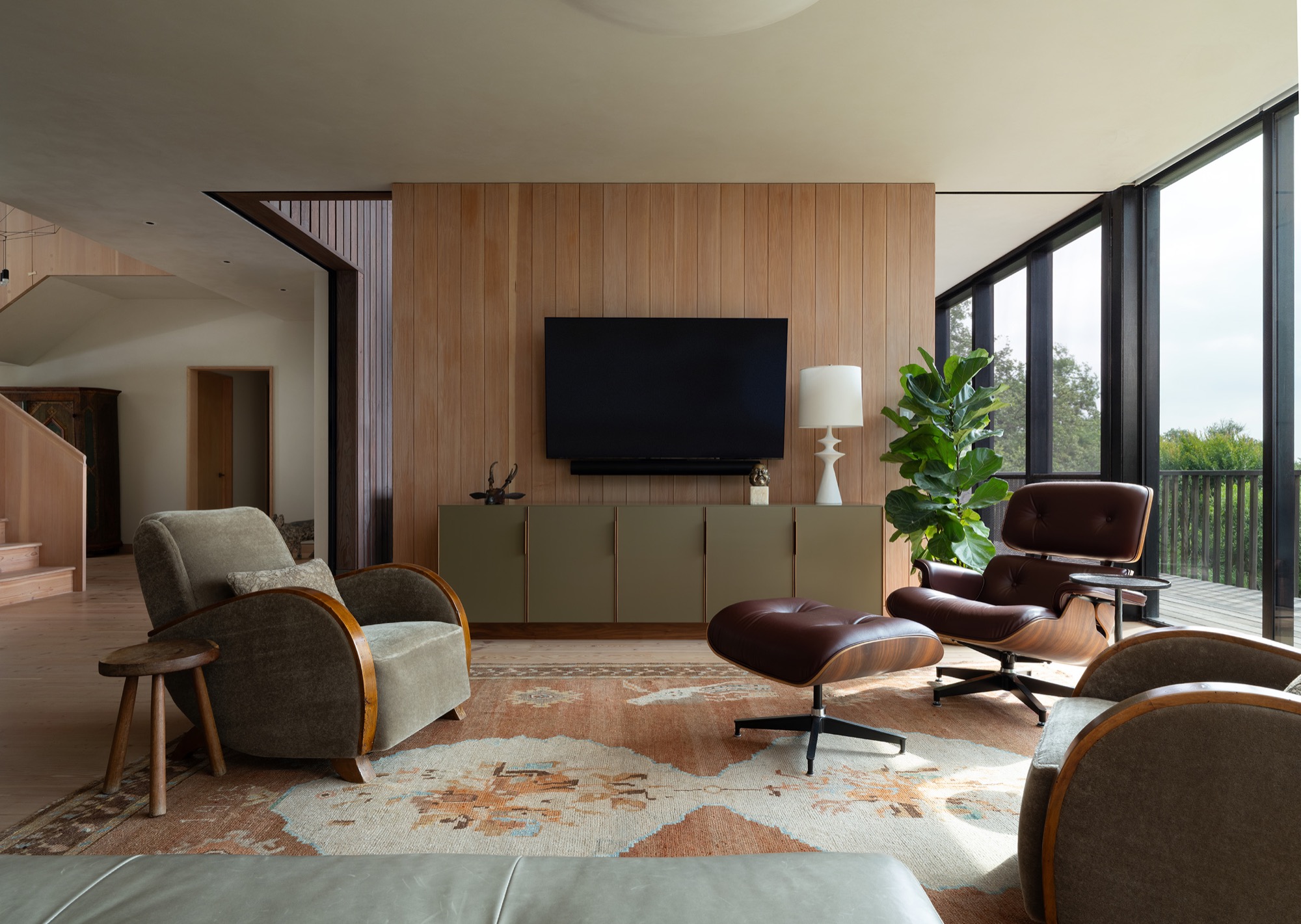 Hillside House living room with Douglas fir paneling in West Lake Hills, Texas